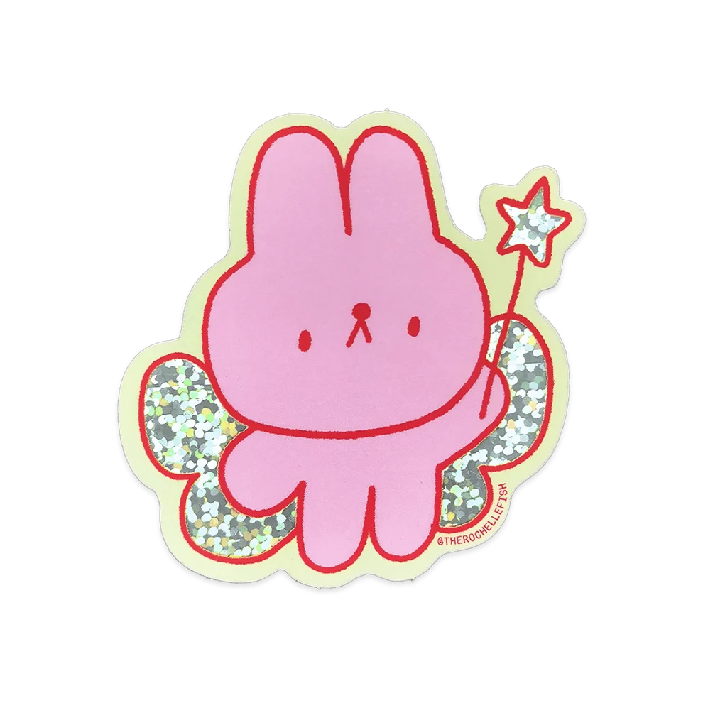 A pink cartoon bunny sticker with red outlines, glittery green wings, and a small star wand, shown on a plain white background.