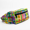 A side view of the farm bumbag. Print is multicoloured lines in a grid pattern. 