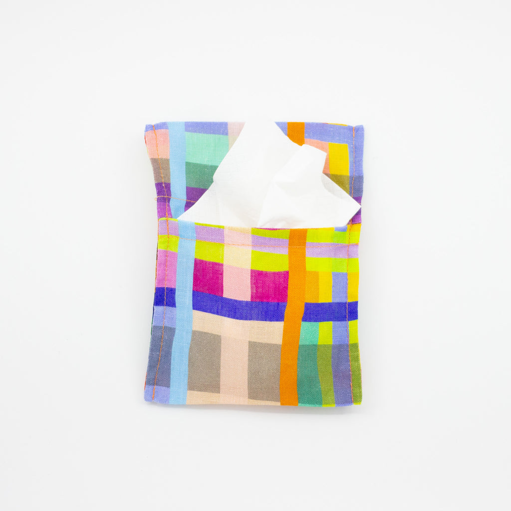 Top view of the Farm pocket tissue holder. In use holding a packet of tissues. This colourful and fun print, with a grid theme, is shuh.’s impression of a birds eye view of a farm