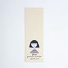 A tall, narrow cream-coloured paper bookmark featuring a minimalist black line drawing of a girl with a bob haircut and the text 'shuh., printed in australia shuhlee.com' at the bottom, shown against a plain white background.