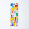 A long bookmark featuring a colourful abstract geometric pattern of painted blocks and dots on a white background.