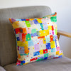Colorful patterned cushion on a gray sofa