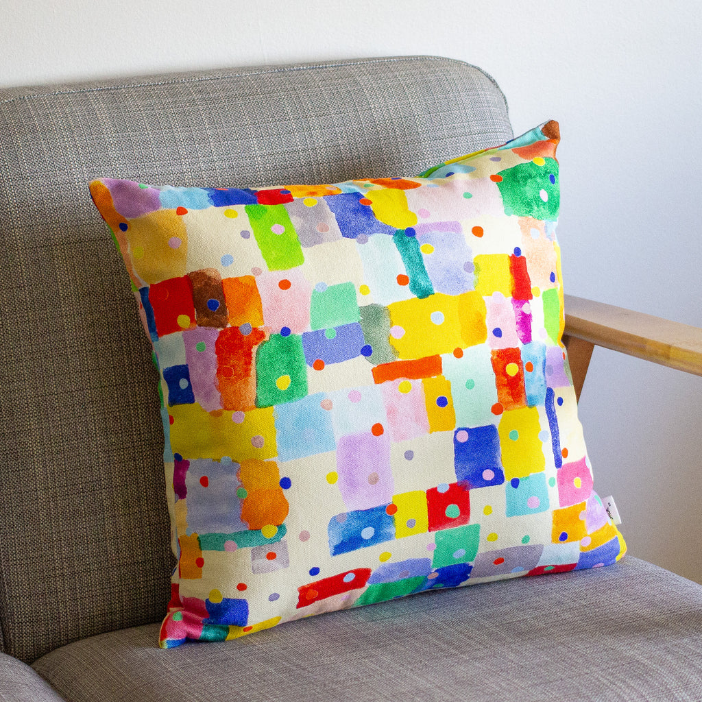 Colorful patterned cushion on a gray sofa