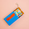 Colourful notebook in a blue box on a peach background