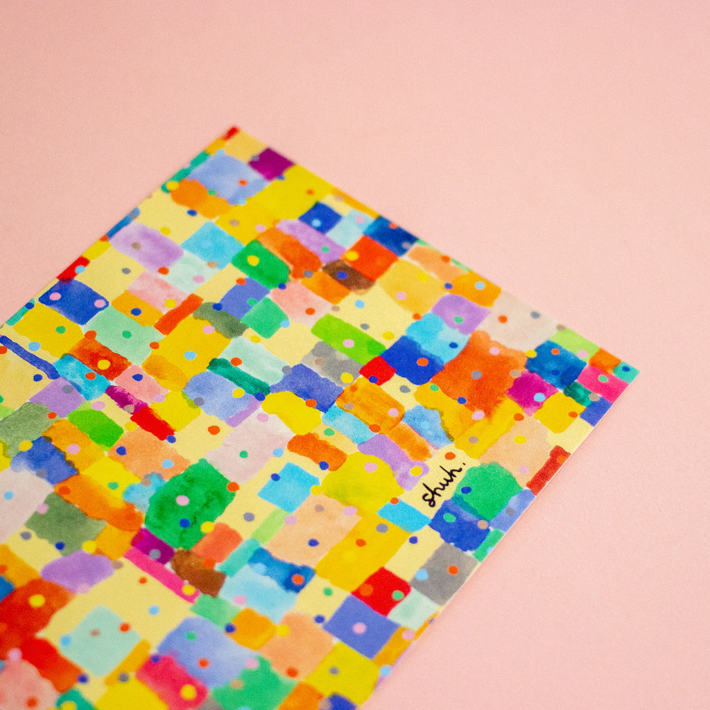 Colourful patterned postcard with 'shuh' branding on a peach background