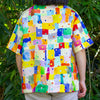 Person wearing a colourful linen shirt with geometric pattern in a natural setting