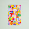 A vertical sticker with a colourful abstract watercolour pattern on a pale mint green background, photographed from directly above.