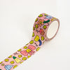 A roll of pink washi tape with a colourful cartoon pattern of flowers, bows, and smiley faces, shown partially unrolled on a white background.