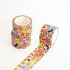 Pink patterned washi tape rolls on a white background, with one roll standing upright and another laid out diagonally showing the repeating cartoon design.
