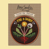Iron-on patch with floral design and 'Anna Seed' branding on a checkered background