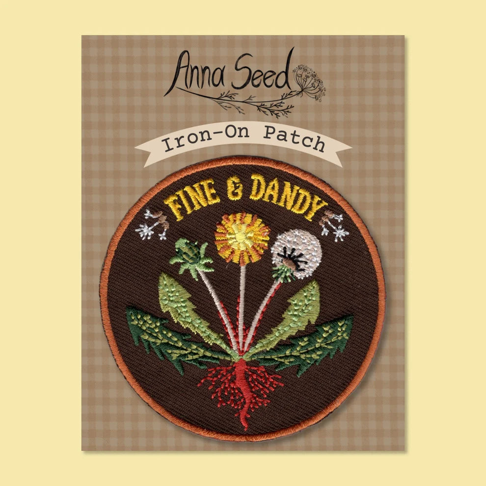 Iron-on patch with floral design and 'Anna Seed' branding on a checkered background
