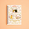 A spiral-bound notebook titled 'SEAL COLLECTION NOTE' with cute cat illustrations and floral designs on a cream cover, photographed against a peach background.