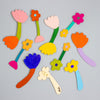 Colourful flower-shaped objects on a grey background
