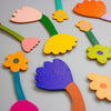 Colourful flower-shaped objects on a grey background