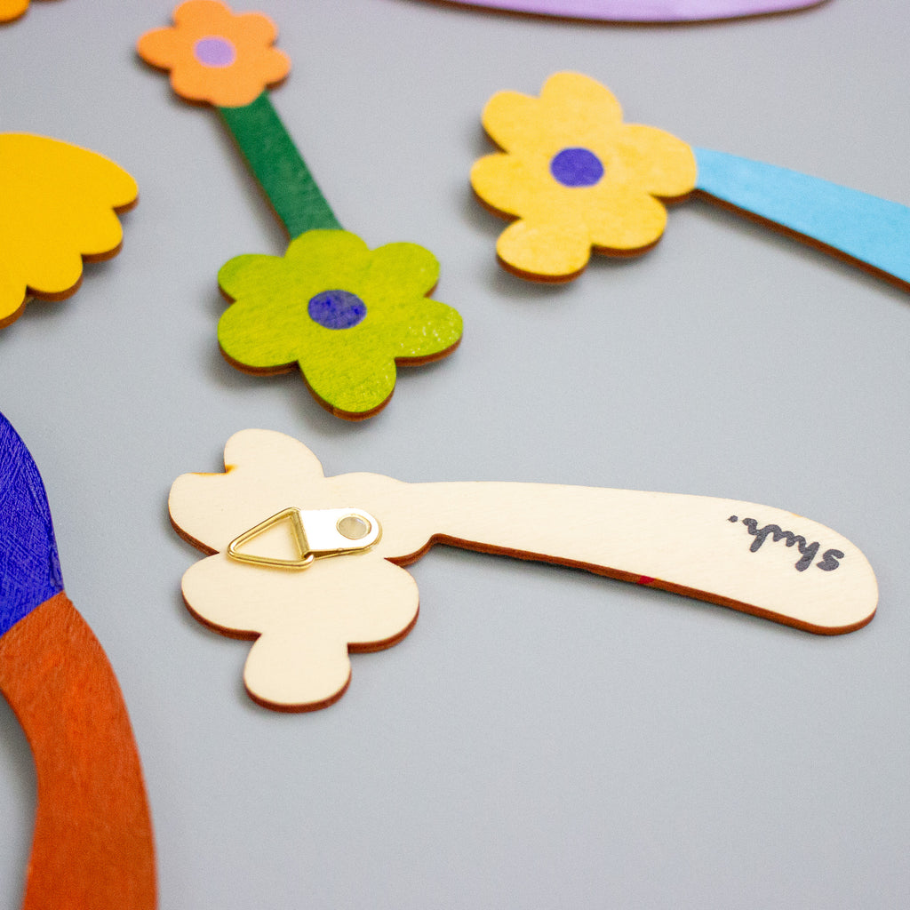 Colourful flower-shaped objects on a grey background
