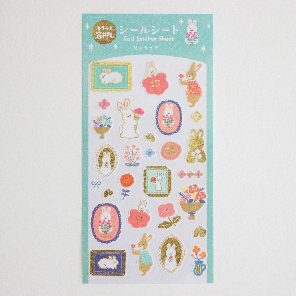 A sheet of Japanese foil sticker sheets featuring cute bunny illustrations, flowers, and decorative frames on a mint green background.
