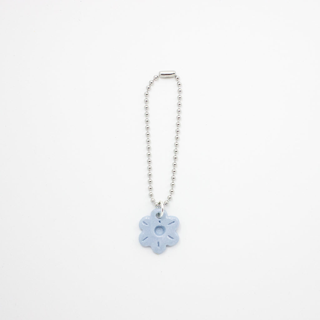 Keychain with a blue flower charm on a white background