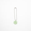 Keychain with a green flower charm on a white background