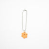 Keychain with an orange flower charm on a white background
