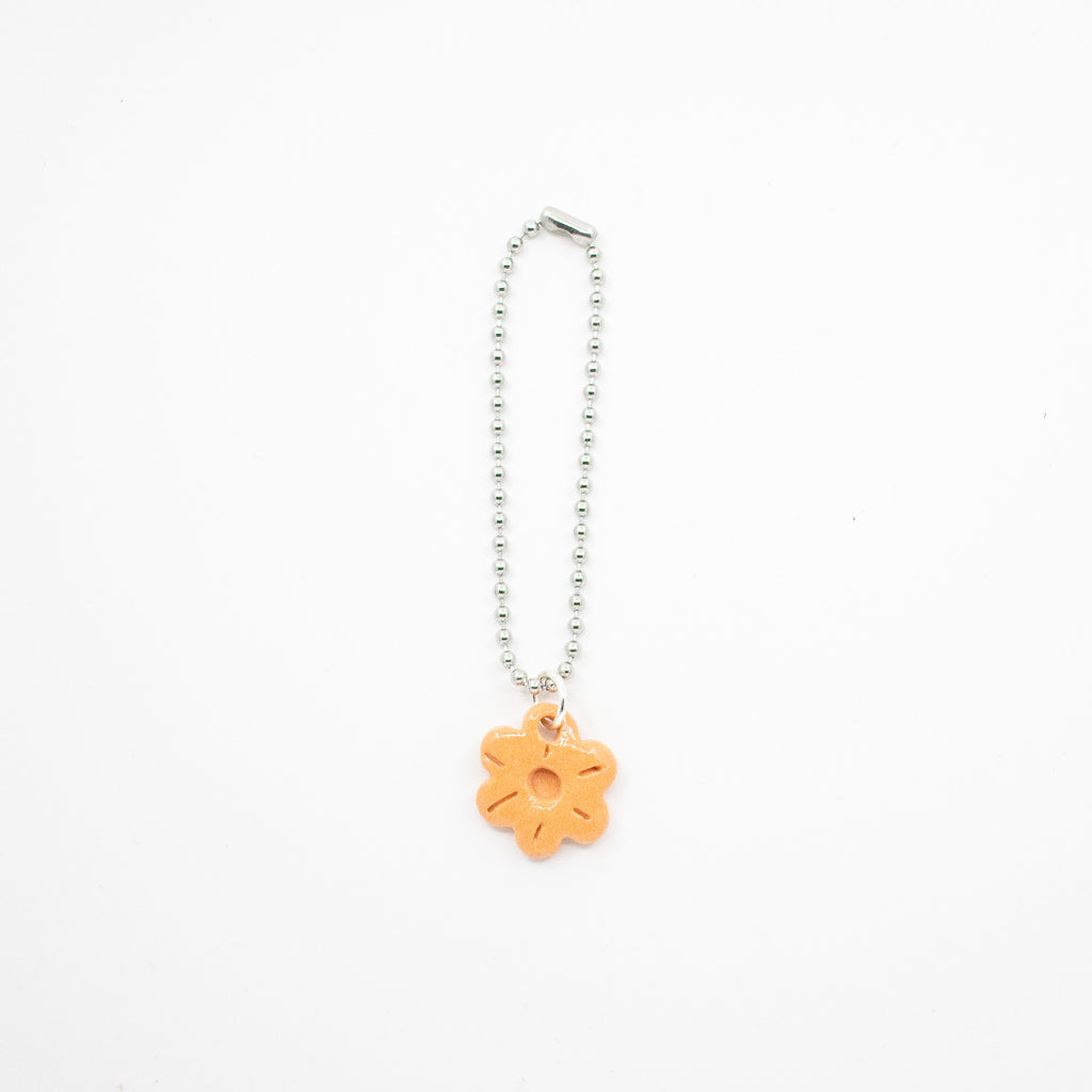 Keychain with an orange flower charm on a white background