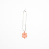 Keychain with a pink flower charm on a white background