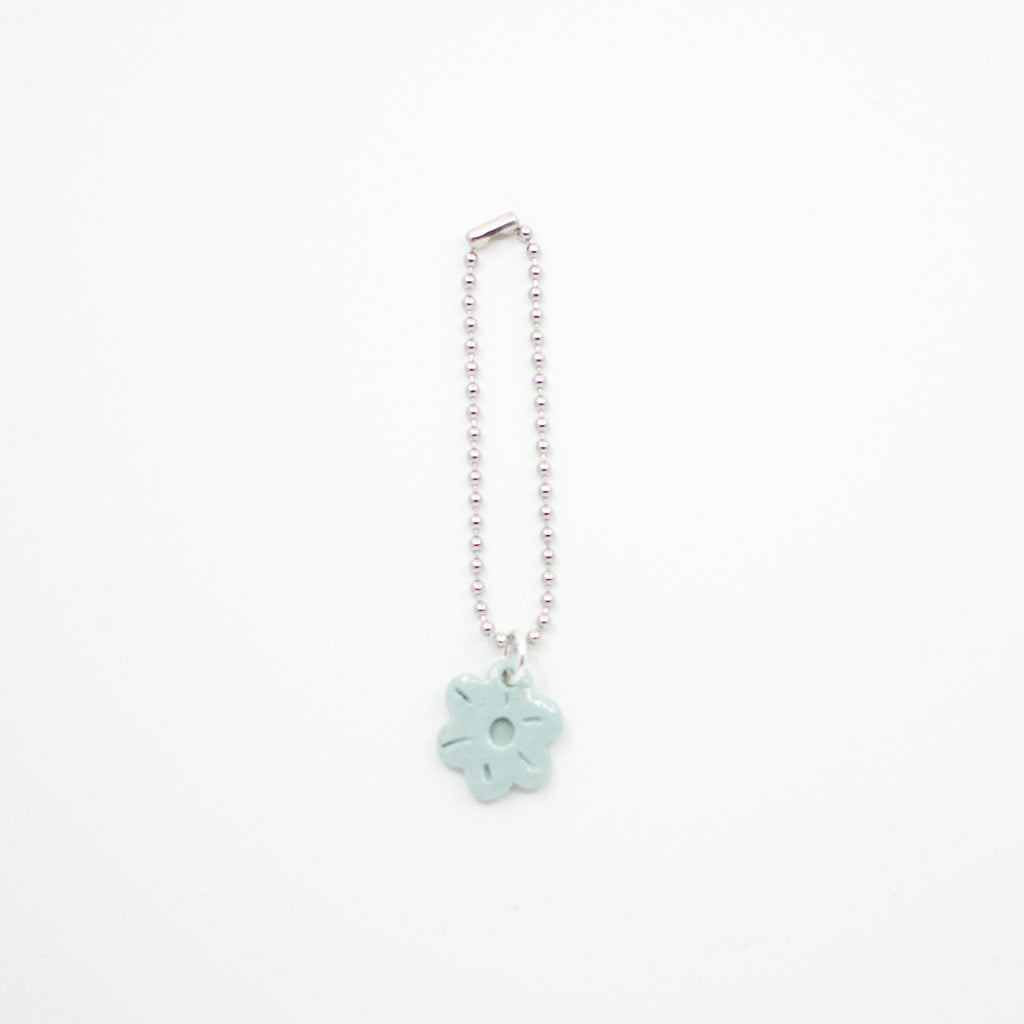 Keychain with a light blue flower charm on a white background