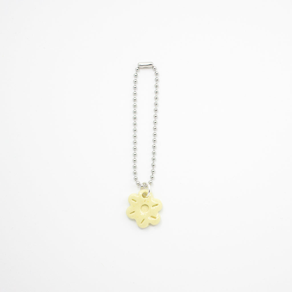 Keychain with a yellow flower charm on a white background