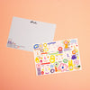 Two rectangular postcards. One featuring the front colourful illustrations with a white background. The other postcard shows the back with a light blue background and shuh. logo on the top. Both postcards are photographed on a peach backdrop. 