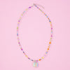 Colourful beaded necklace with a floral charm on a pink background