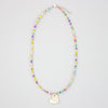 Colourful beaded necklace with a heart-shaped pendant on a light grey background