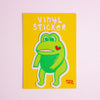 Vinyl sticker with a green cartoon character on a yellow background