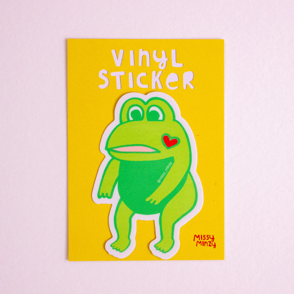 Vinyl sticker with a green cartoon character on a yellow background