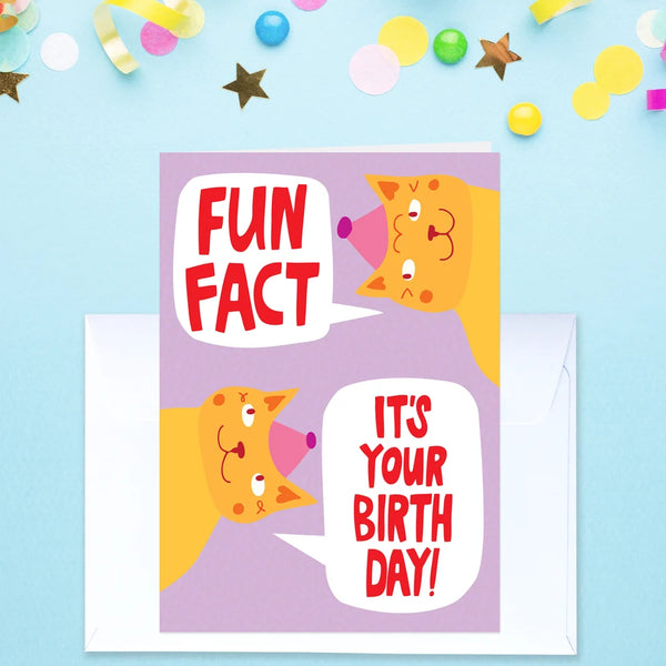 A funny greeting card with a white envelope, featuring cartoon orange cats and the text 'FUN FACT' and 'IT'S YOUR BIRTH DAY!' on a light blue background with confetti.