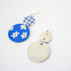 Pair of earrings with blue and white floral designs on a white background