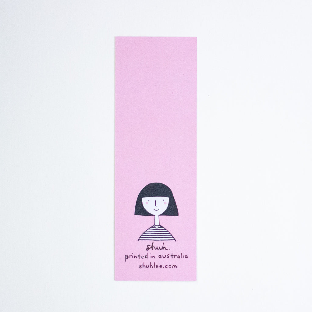 A tall, narrow pink bookmark with a simple black line drawing of a person and the text 'shuh. printed in australia shuhlee.com'