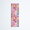 A colourful floral-patterned bookmark with pink, orange, yellow, green, and blue flowers, shown against a plain white background.