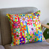 Colorful floral-patterned pillow on a gray sofa