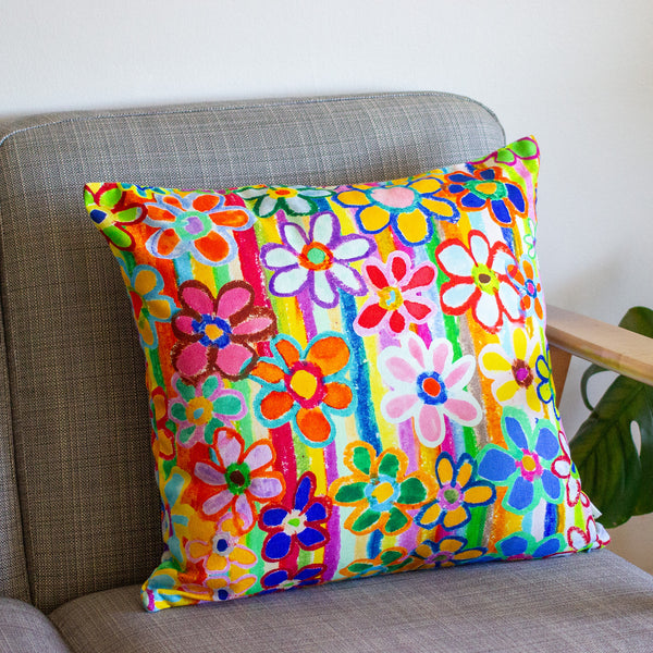 Colorful floral-patterned pillow on a gray sofa