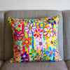 Colorful floral-patterned pillow on a gray couch
