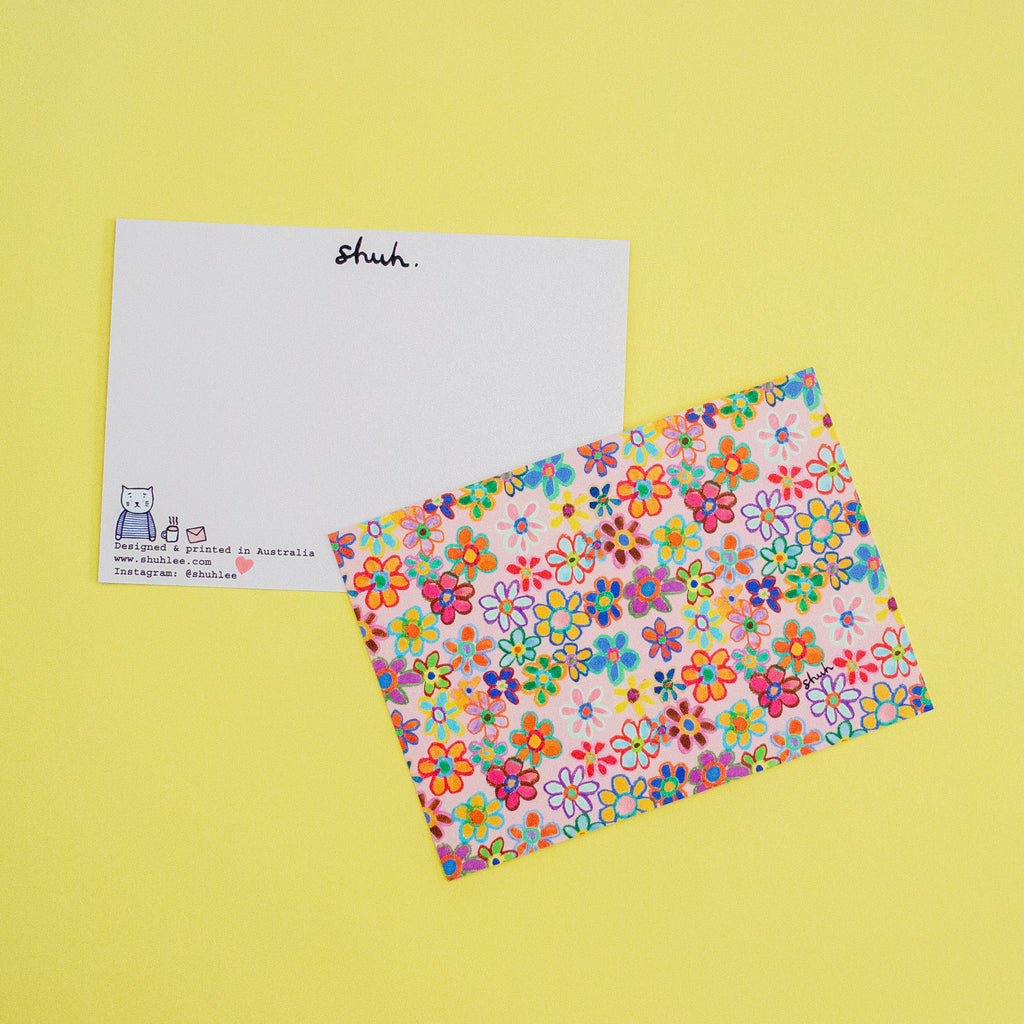 Colorful floral-patterned Postcard on a yellow background. Front and Back pictured. 