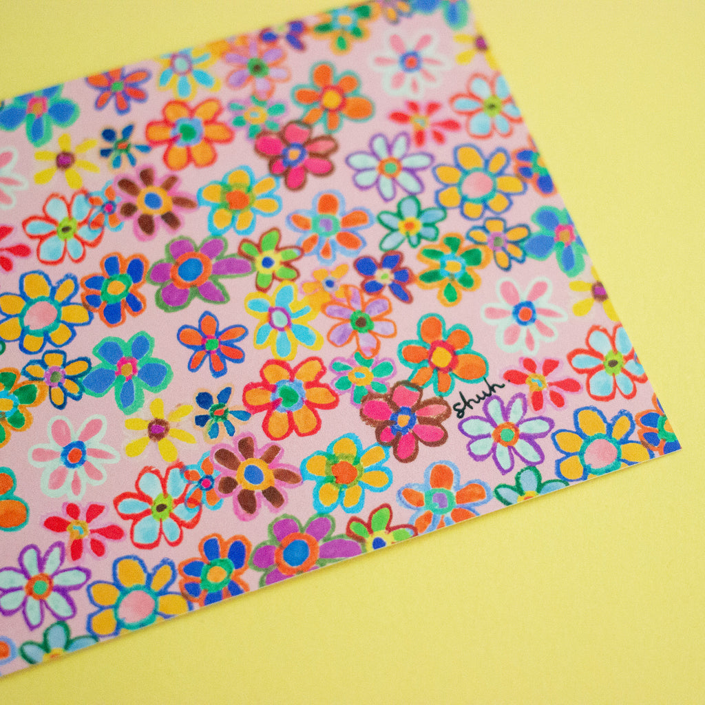 Colorful floral patterned post card with 'Shuh' branding on a yellow background