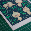 Illustration of cartoon garlics on a dark blue background with green leaves.