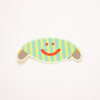 Gerty, an oval monster with striped body and arms, and a bright red smile. 