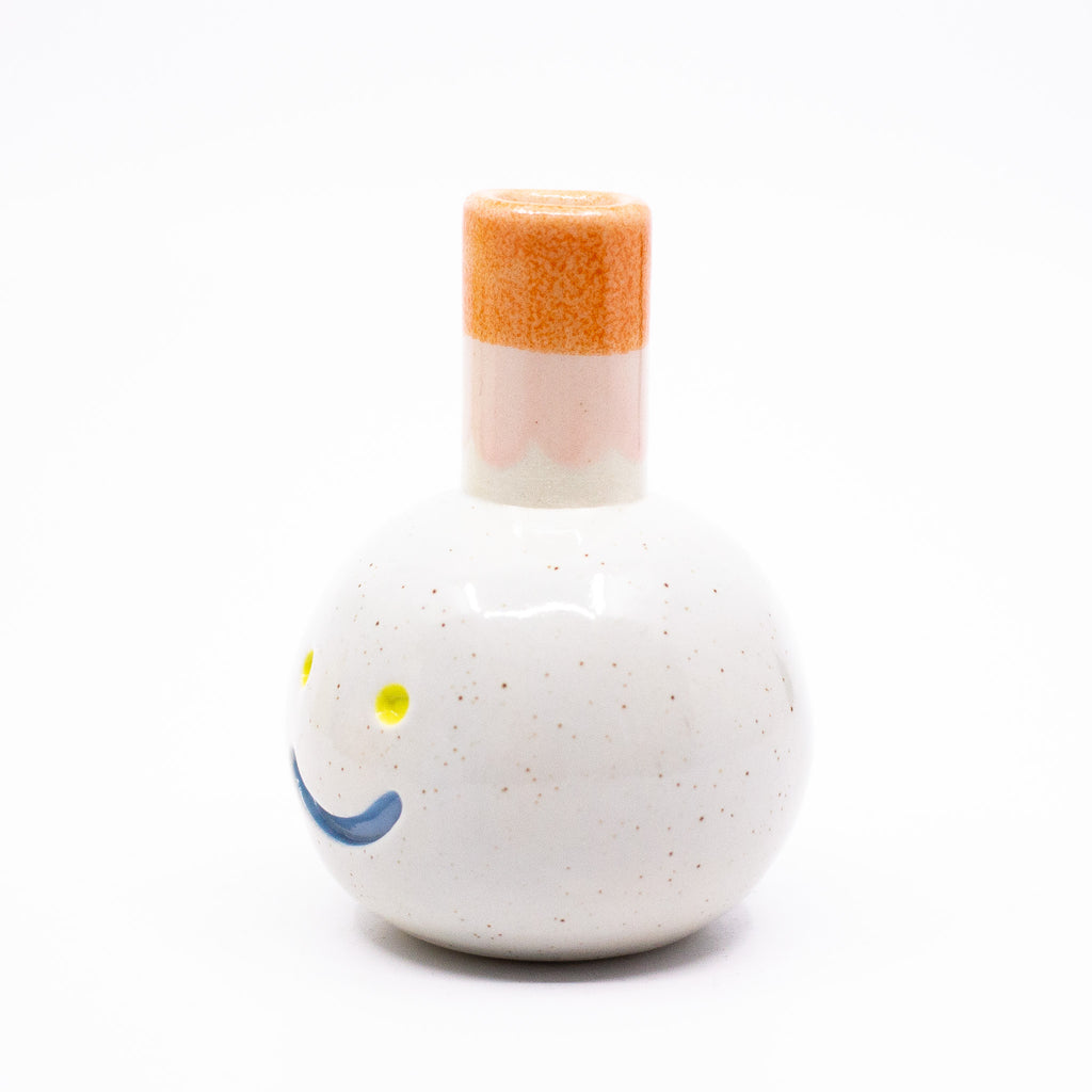 Side view of the Gerty vase. White body with orange chimney. 