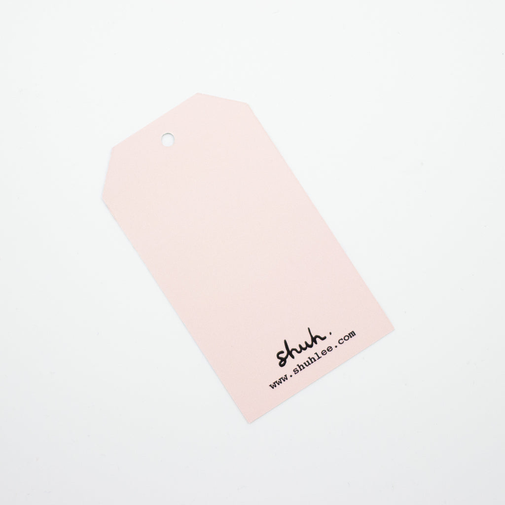 A closeup of the reverse blank side of the creatures gift tag. 