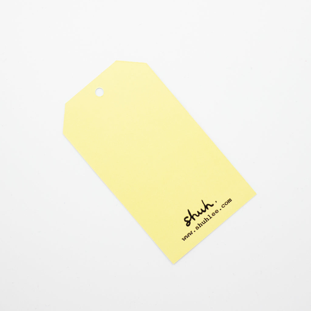 A closeup picture of the squares gift tag. This photo shows the blank reverse side of the tag. 