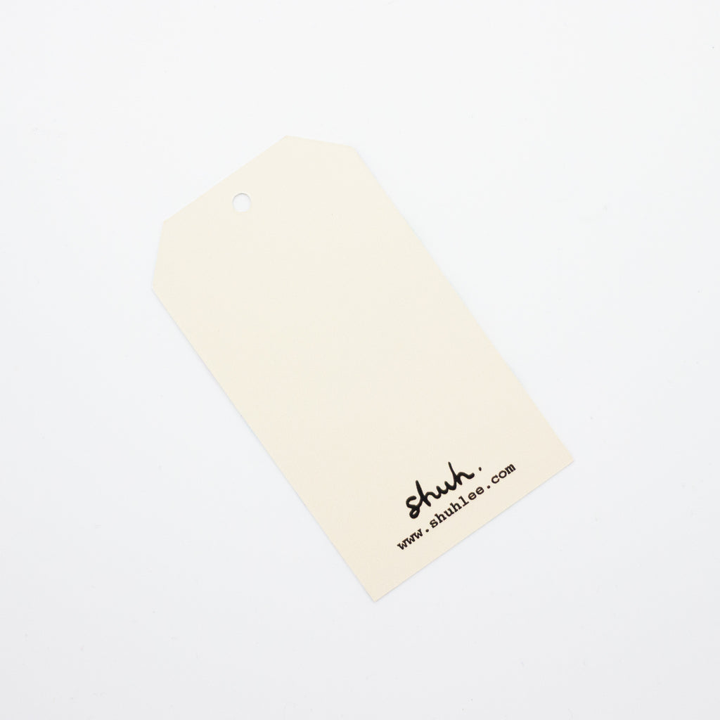 A closeup of the shuh. tulip gift tag. This shows the blank reverse side. 
