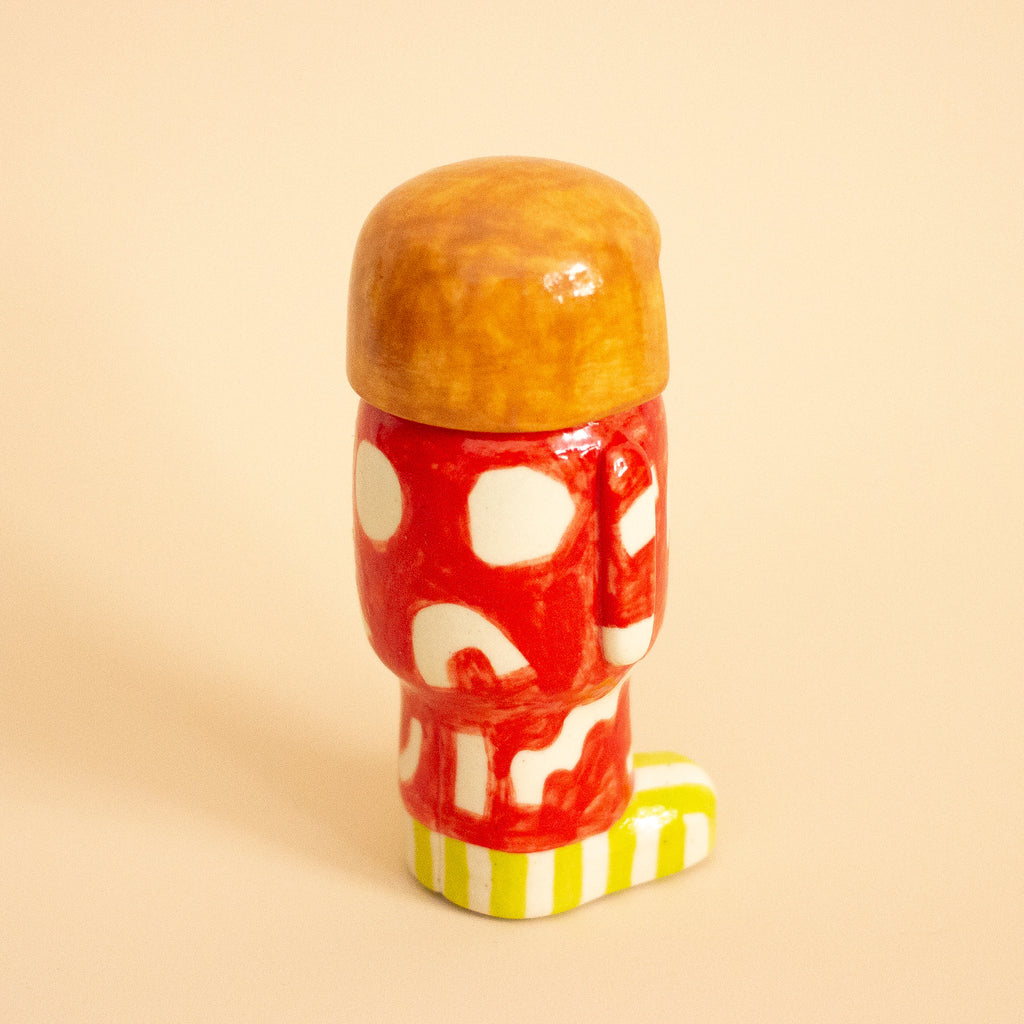 Decorative figure with a red and white pattern on a beige background