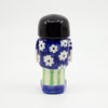 A Back view of the girl figurine number 5 with daisy pattern. 