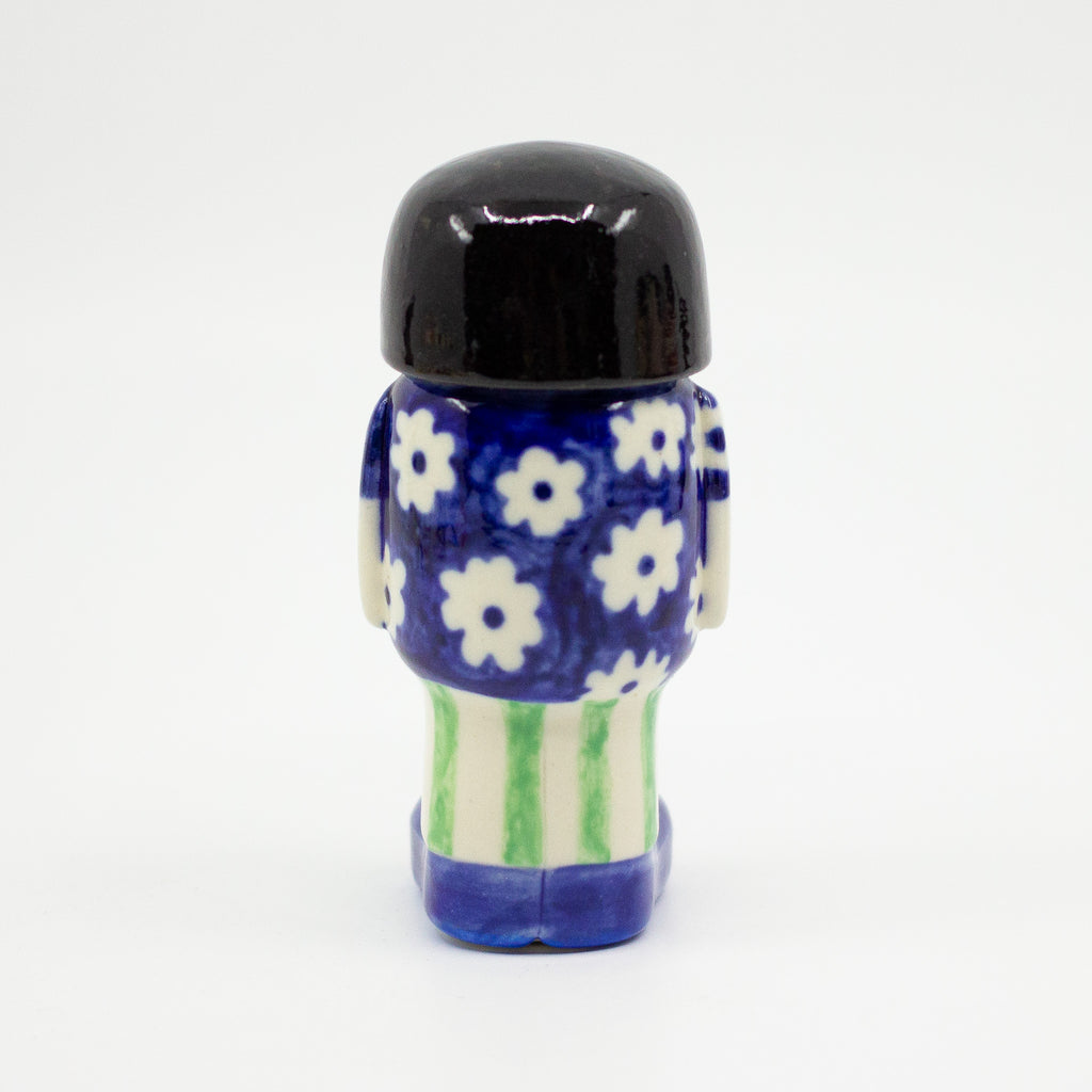 A Back view of the girl figurine number 5 with daisy pattern. 